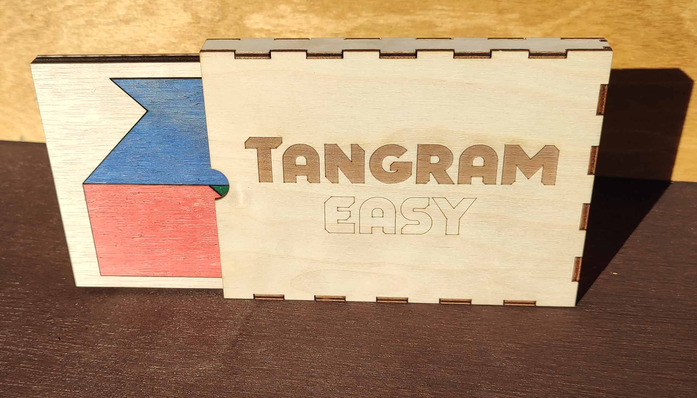 Tangram Easy wooden case with the puzzle board partially removed